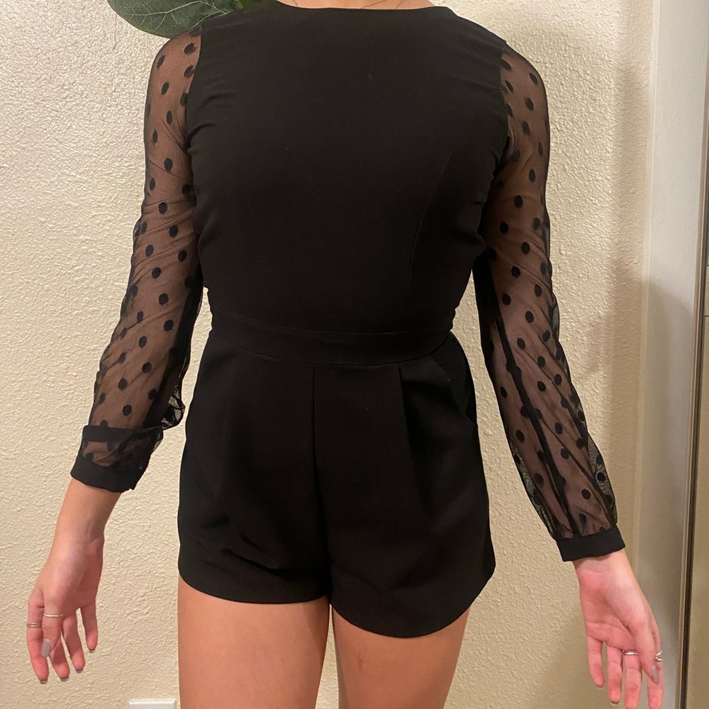 fitted black romper with black sheer sleeves